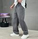 Men's relaxed straight-leg denim jeans shown with white trainers