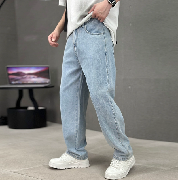 Men's relaxed straight-leg denim jeans shown with white trainers