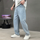 Men's relaxed straight-leg denim jeans shown with white trainers