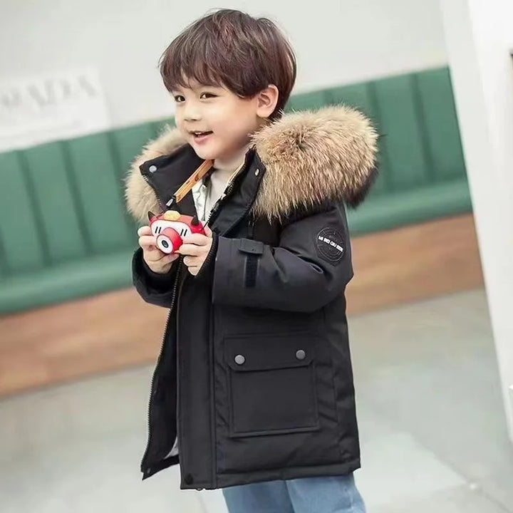 Boys' longline parka with fur-trimmed hood, zip fastening and flap pockets