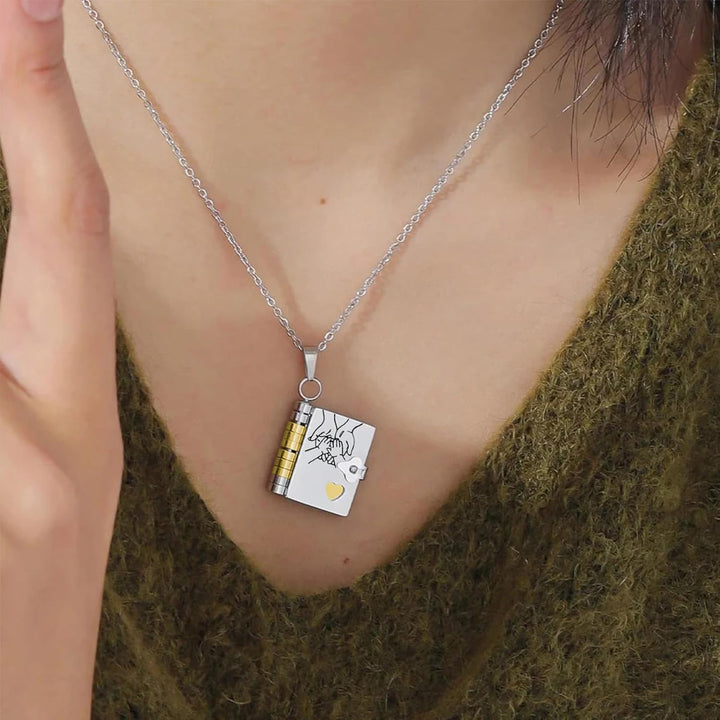 Miniature book charm pendant in gold and silver with chain and matching tortoiseshell case