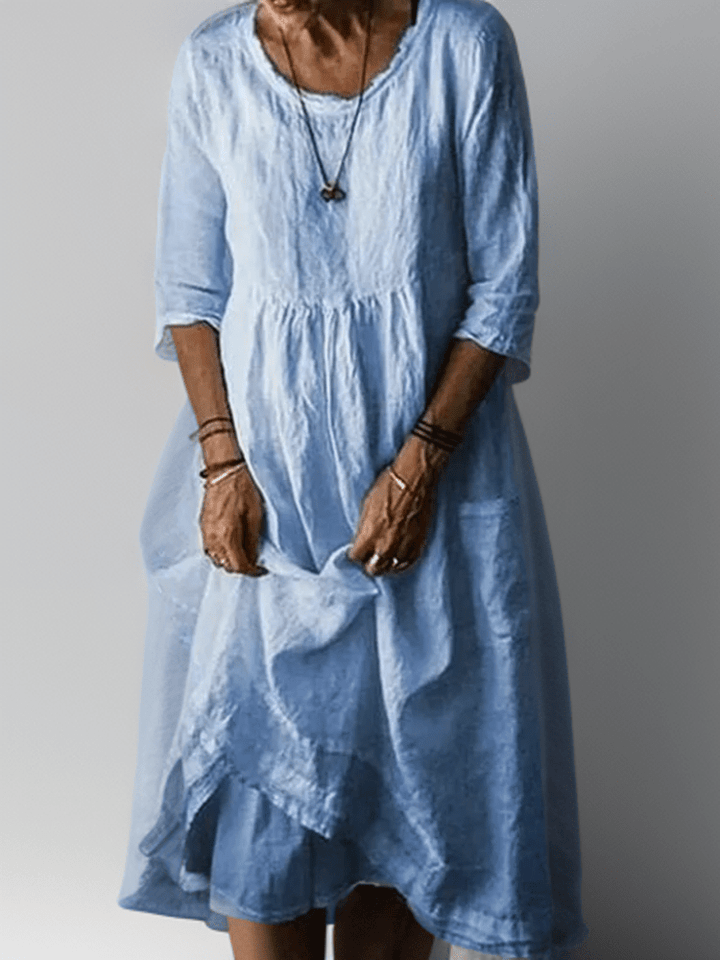Women's flowing maxi dress with three-quarter sleeves and layered hem, scoop neckline