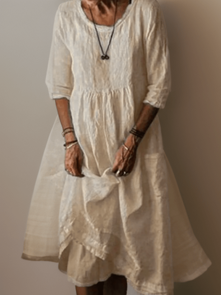 Women's flowing maxi dress with three-quarter sleeves and layered hem, scoop neckline