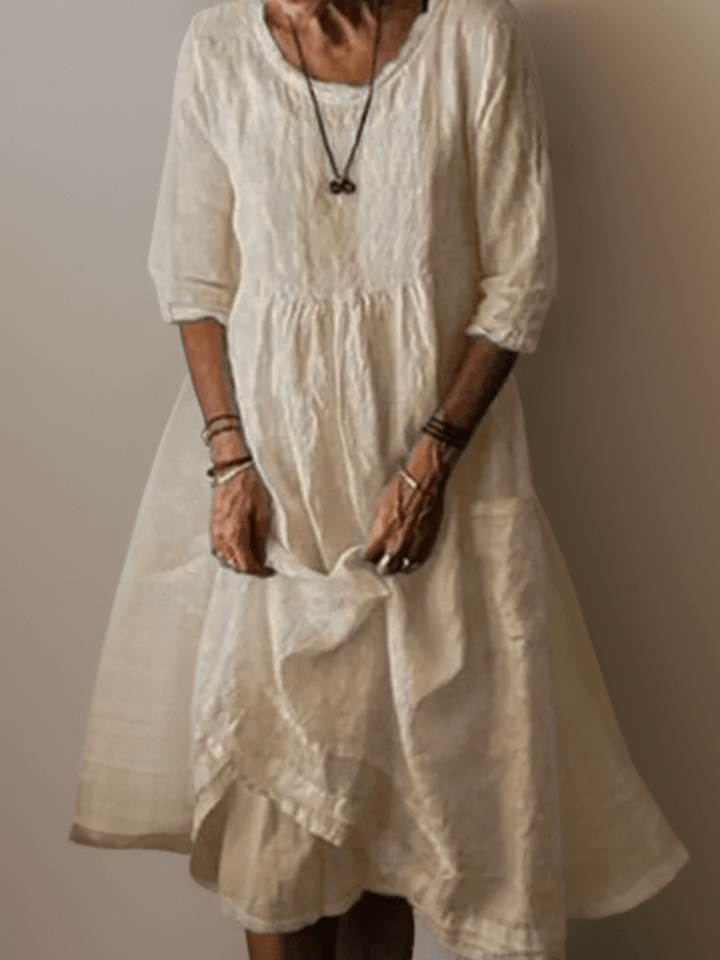 Women's flowing maxi dress with three-quarter sleeves and layered hem, scoop neckline