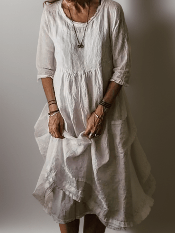 Women's flowing maxi dress with three-quarter sleeves and layered hem, scoop neckline
