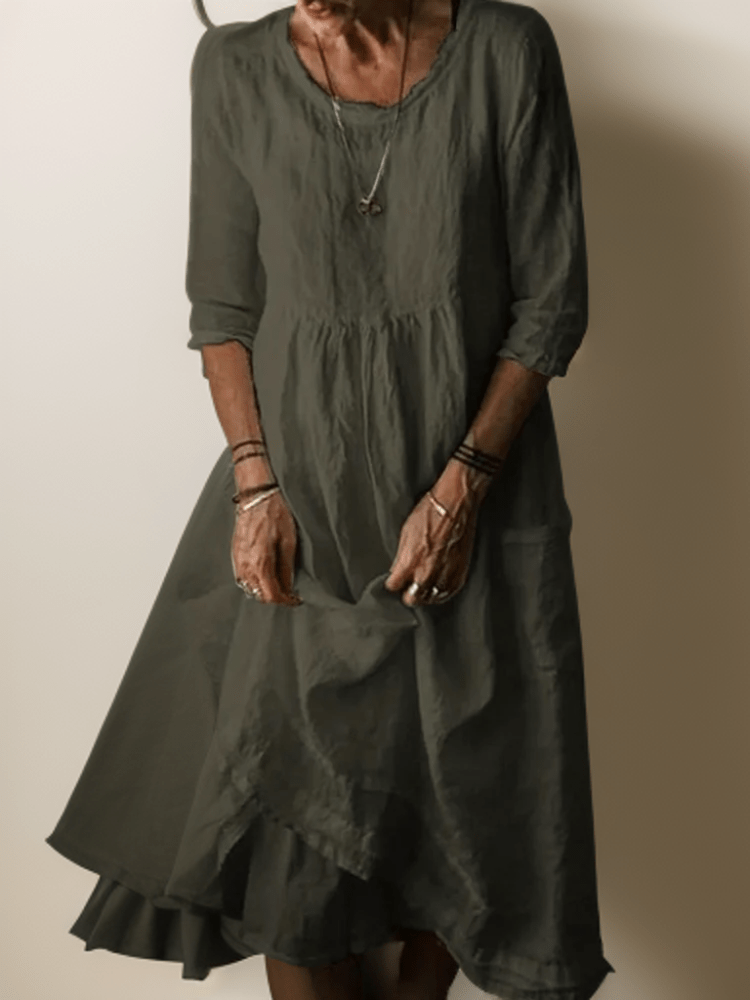 Women's flowing maxi dress with three-quarter sleeves and layered hem, scoop neckline