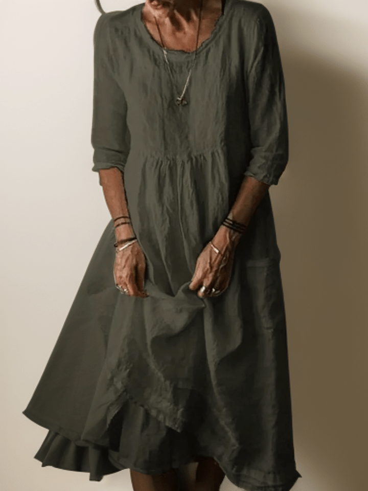 Women's flowing maxi dress with three-quarter sleeves and layered hem, scoop neckline