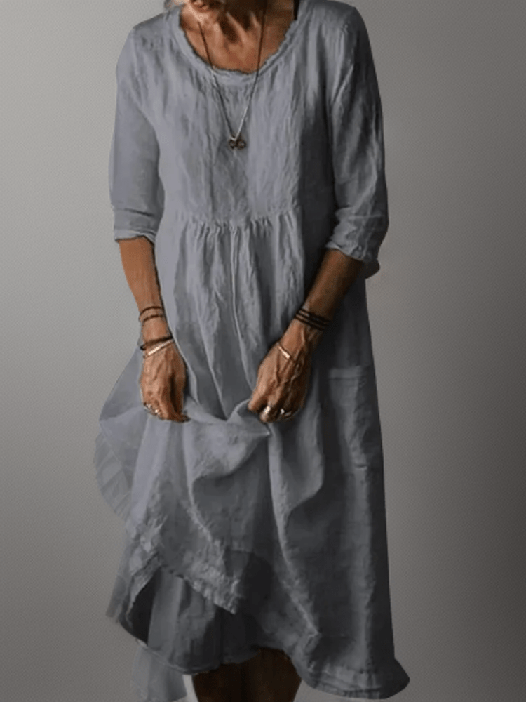 Women's flowing maxi dress with three-quarter sleeves and layered hem, scoop neckline