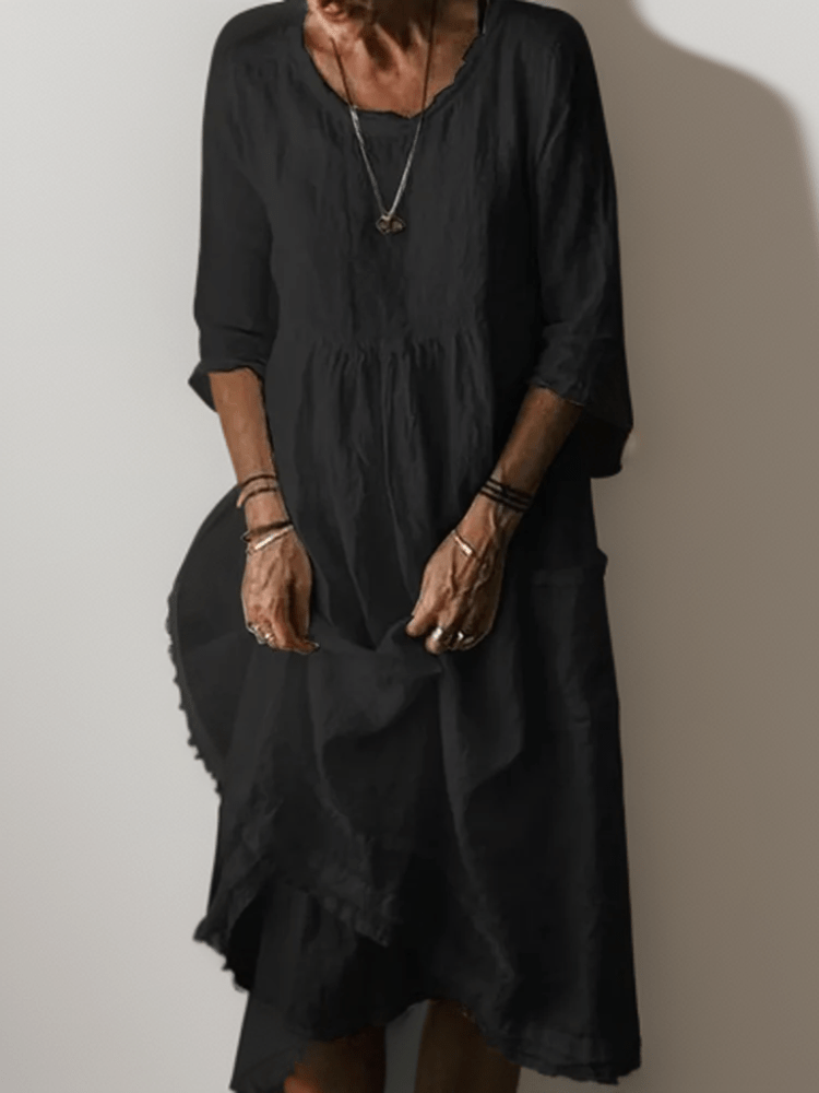 Women's flowing maxi dress with three-quarter sleeves and layered hem, scoop neckline