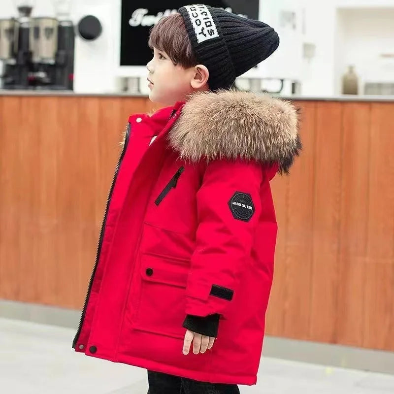 Boys' longline parka with fur-trimmed hood, zip fastening and flap pockets