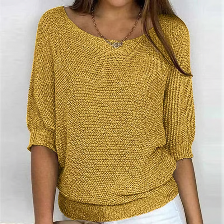 Women's relaxed textured knit sweater with round neckline and three-quarter sleeves