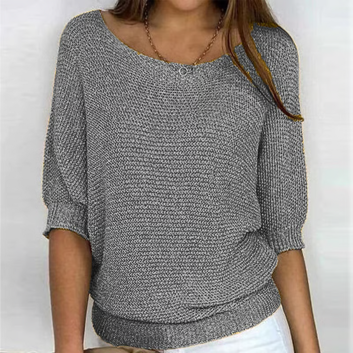 Women's relaxed textured knit sweater with round neckline and three-quarter sleeves