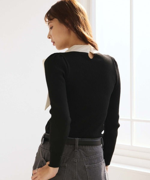 Women's black ribbed jumper with white collar and large ribbon bow
