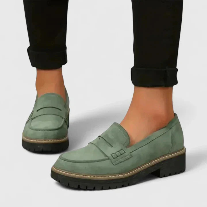 Women's black platform loafer with lug sole and padded band, shown on foot with jeans; also shown in pink with contrast sole and stitching