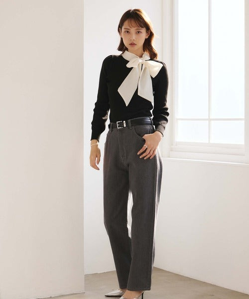 Women's black ribbed jumper with white collar and large ribbon bow