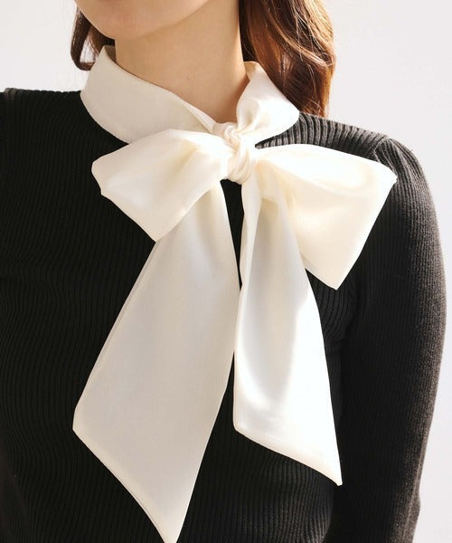 Women's black ribbed jumper with white collar and large ribbon bow
