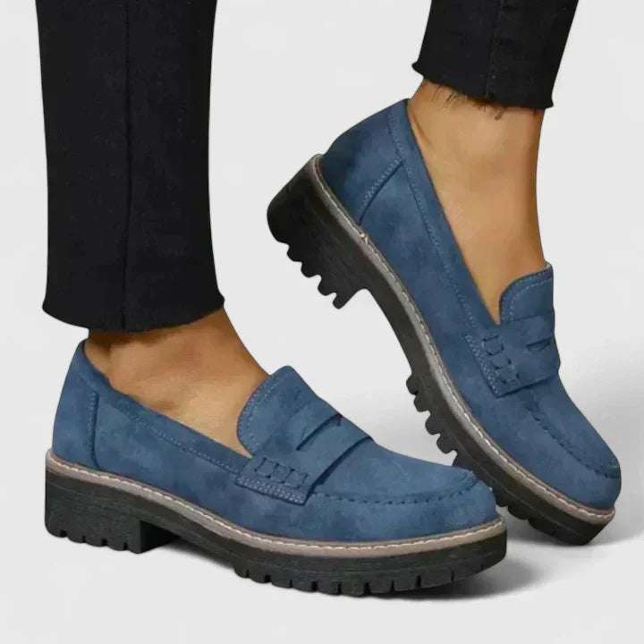 Women's black platform loafer with lug sole and padded band, shown on foot with jeans; also shown in pink with contrast sole and stitching