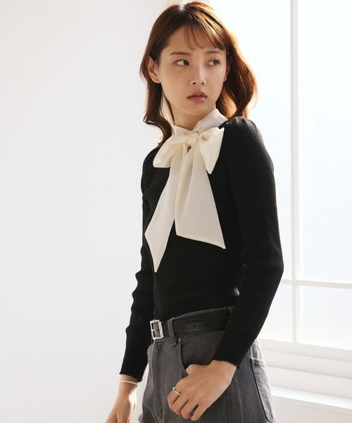 Women's black ribbed jumper with white collar and large ribbon bow