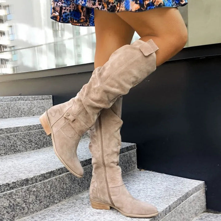 Women's slouch knee high boots with low heel, side zip and decorative straps