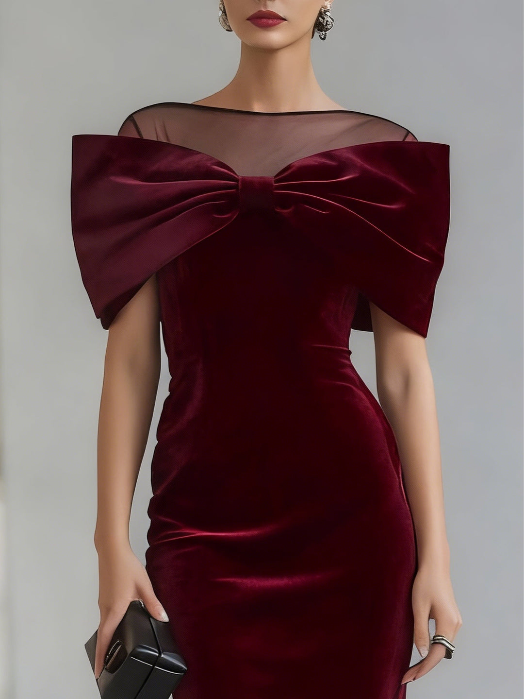 Women's burgundy velvet midi dress with oversized bow and sheer boat neckline