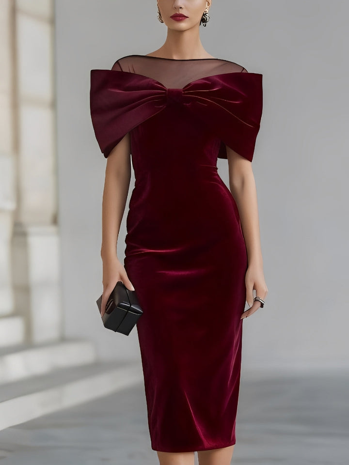 Women's burgundy velvet midi dress with oversized bow and sheer boat neckline