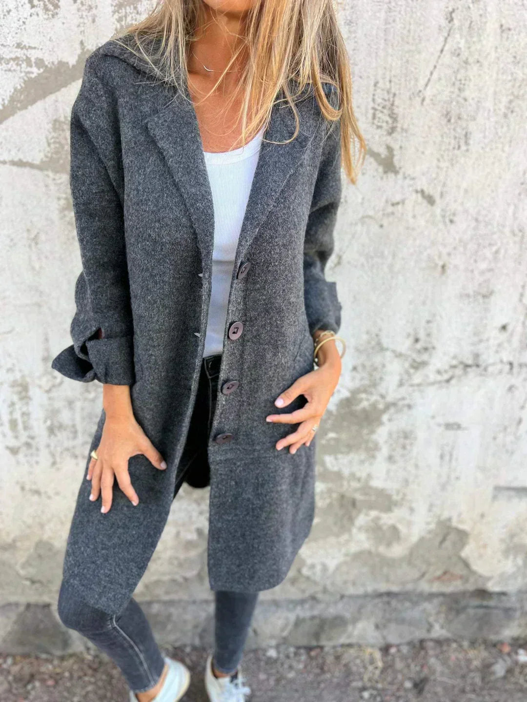 Women's long button-front coat with notched lapels and patch pockets