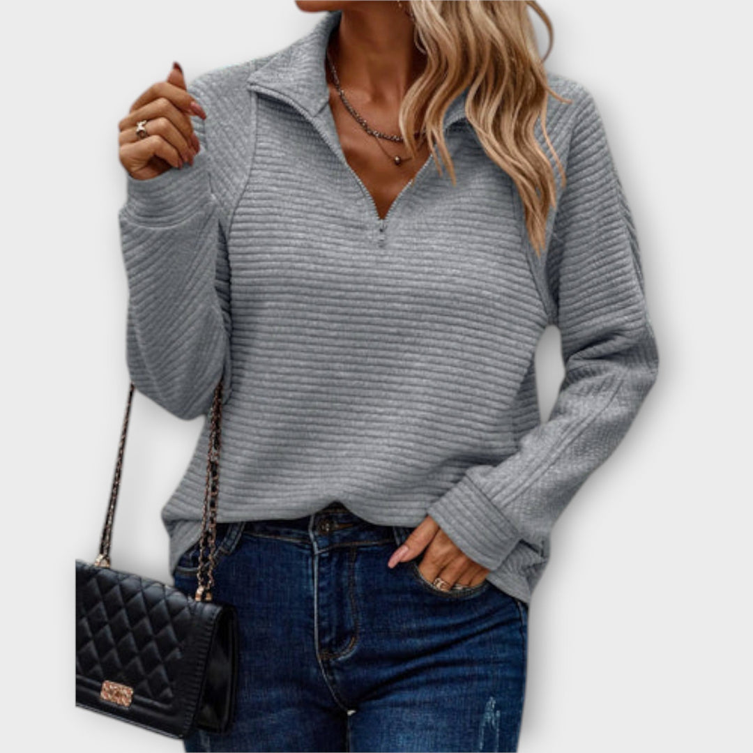 Women's ribbed knit sweater with raised collar and zip neck