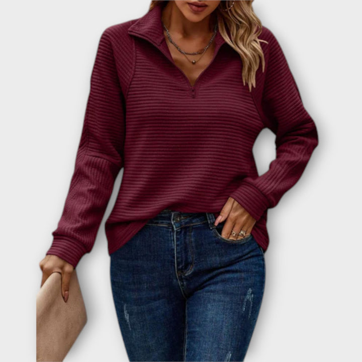 Women's ribbed knit sweater with raised collar and zip neck