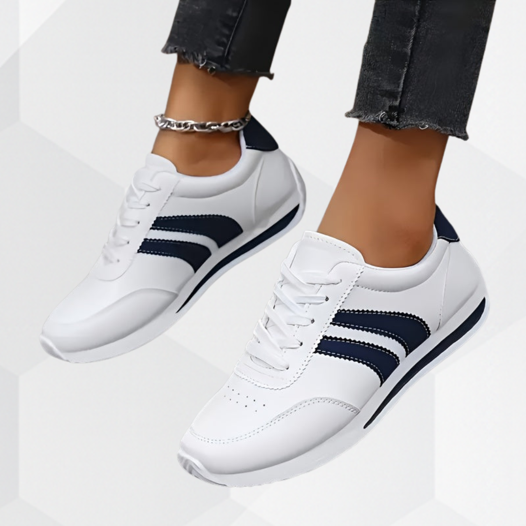 White lace-up trainers with navy side stripes and flat soles