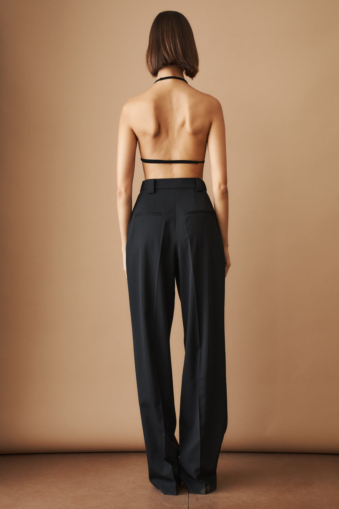 Women's black high-waisted wide-leg trousers with pleated front and side pockets