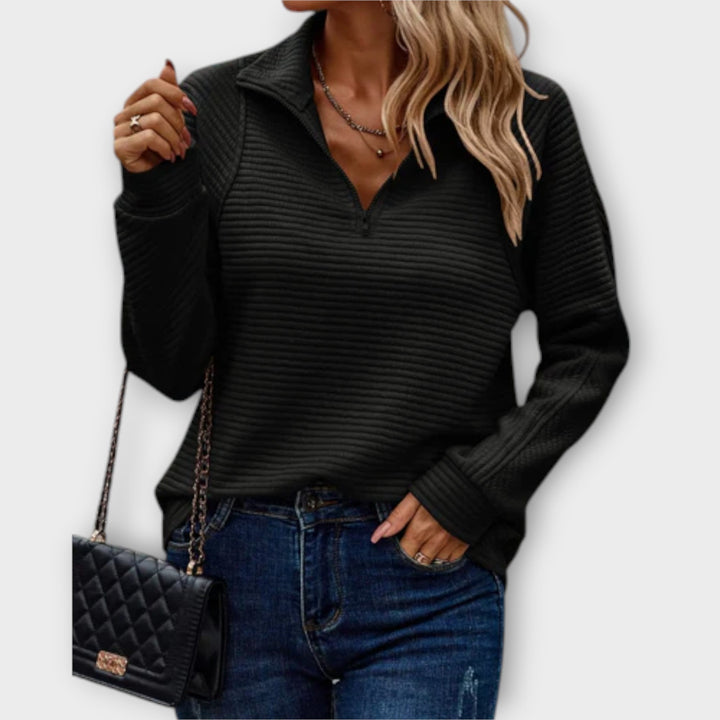 Women's ribbed knit sweater with raised collar and zip neck