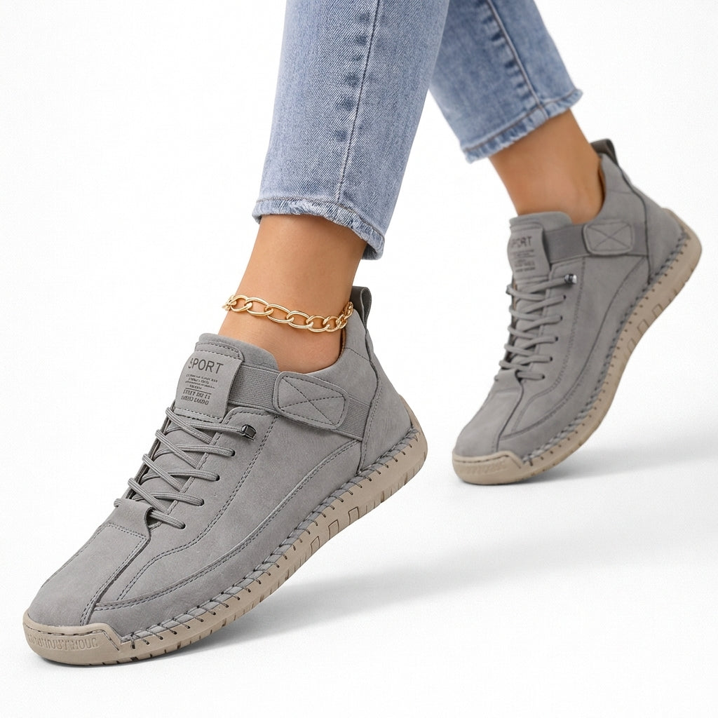 Women's low-top lace-up sneakers with stitched panels, strap detail and flat textured soles