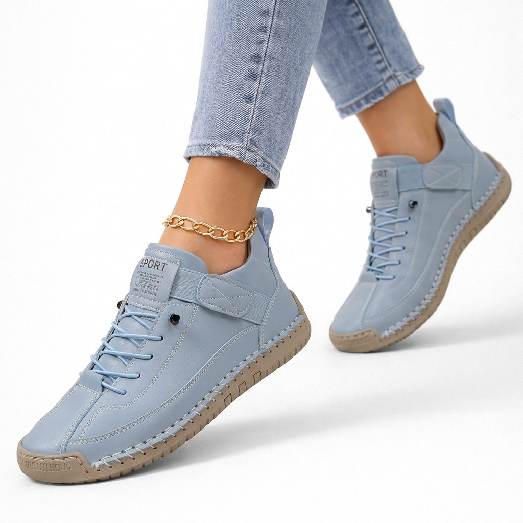 Women's low-top lace-up sneakers with stitched panels, strap detail and flat textured soles
