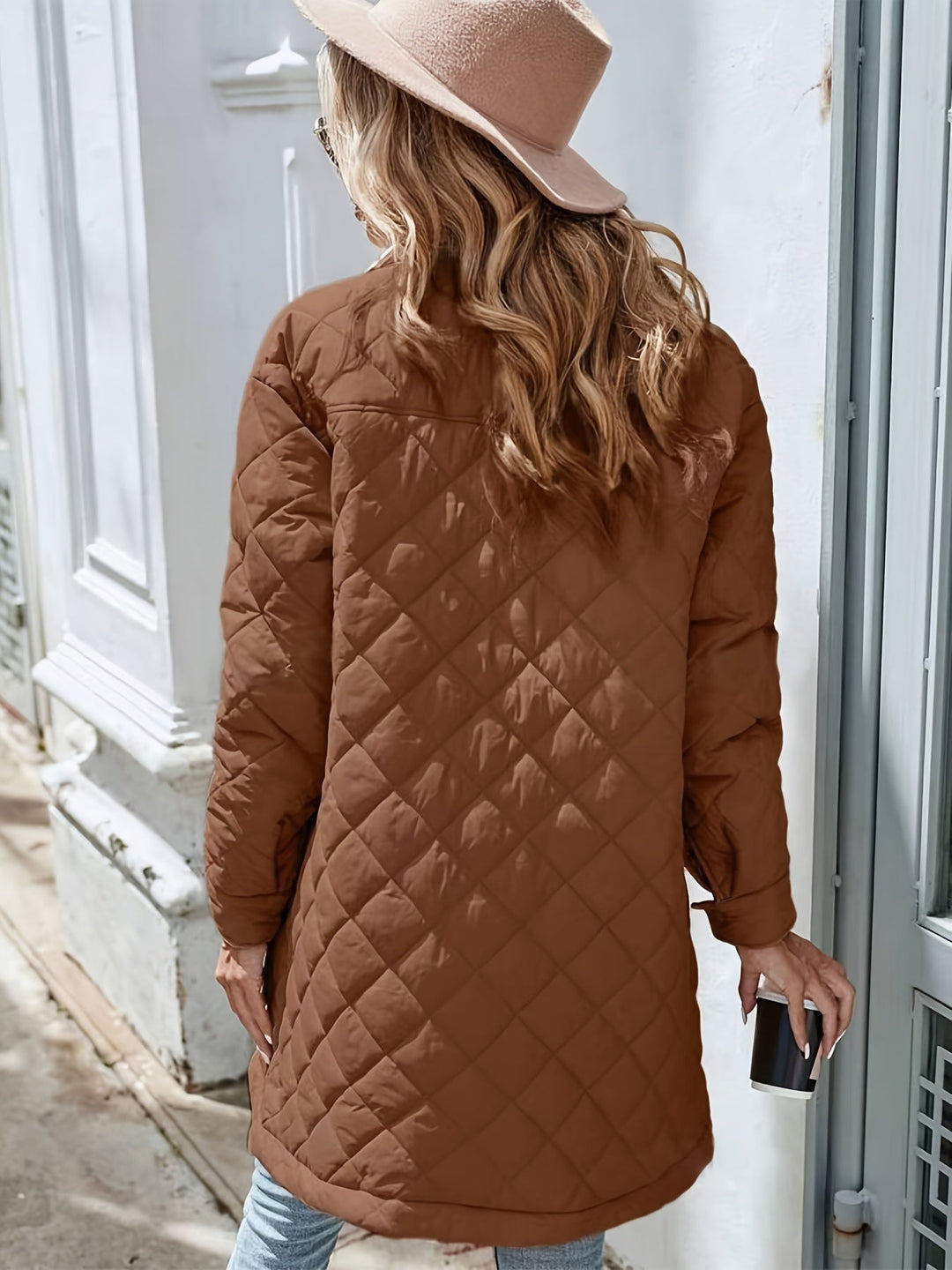 Women's brown longline quilted puffer jacket with snap buttons