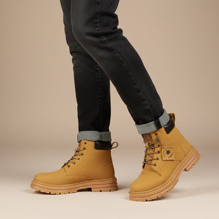 Men's ankle-height lace-up boots with padded collar, round toe and lug sole