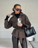 Women's short belted trench coat with notched lapels and long sleeves