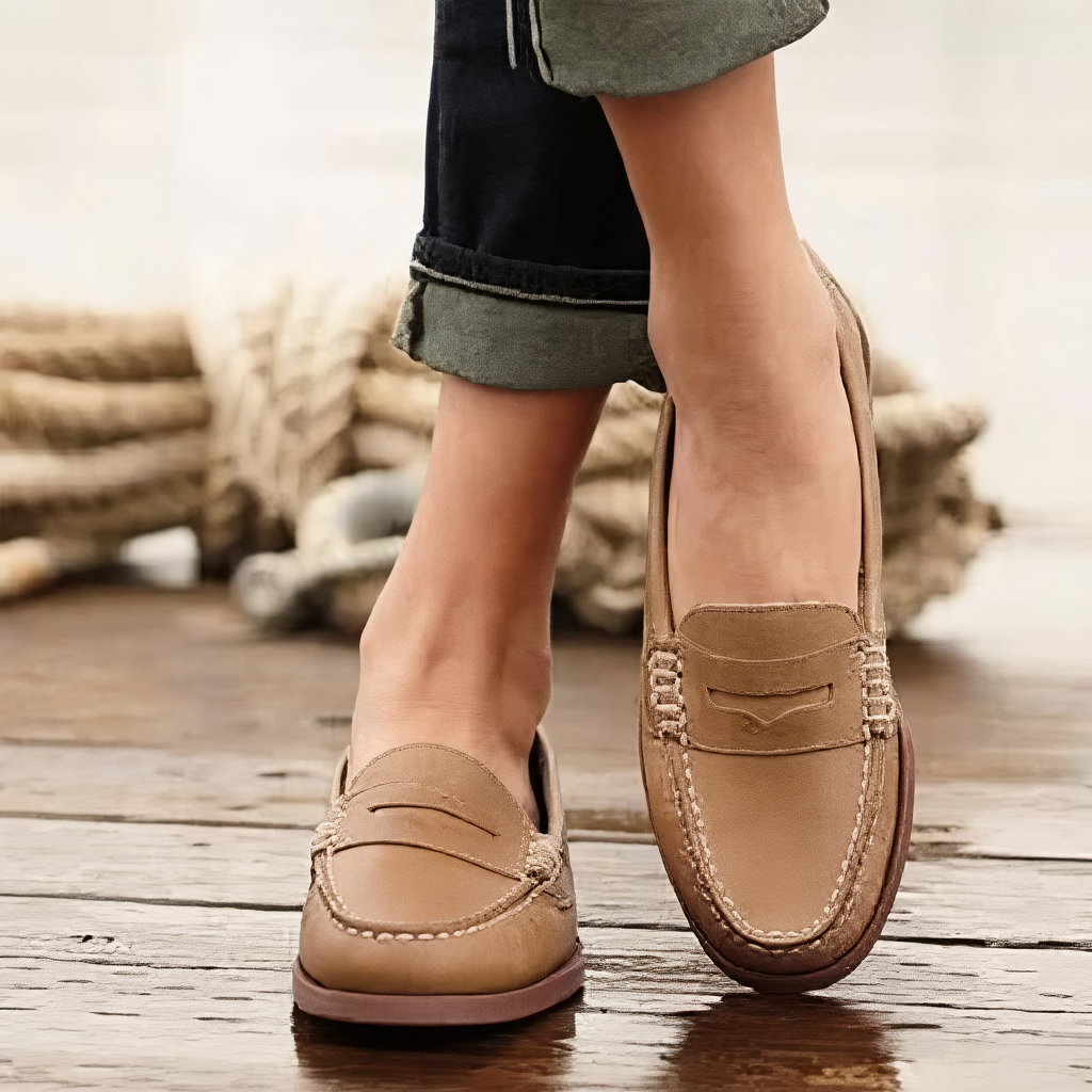 Women's slip-on loafers with moc toes, penny strap detail and low heels