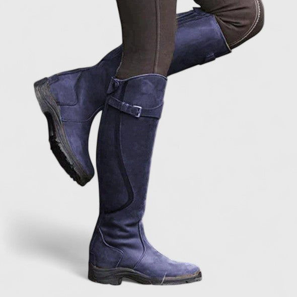 Women's cushioned orthopedic boots with adjustable buckle strap, suede-like upper, and grooved sole.