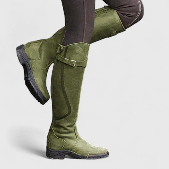 Women's cushioned orthopedic boots with adjustable buckle strap, suede-like upper, and grooved sole.