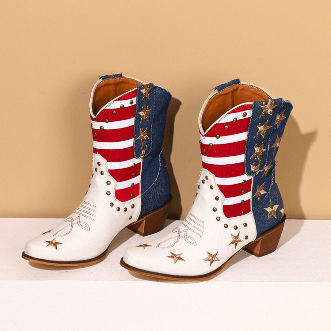White cowboy boots with red stripes, blue panels and gold star details