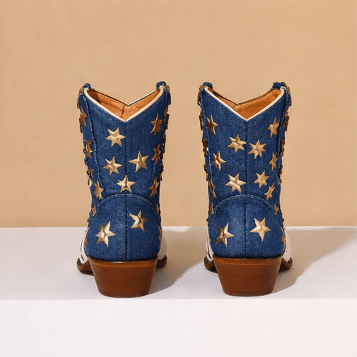 White cowboy boots with red stripes, blue panels and gold star details