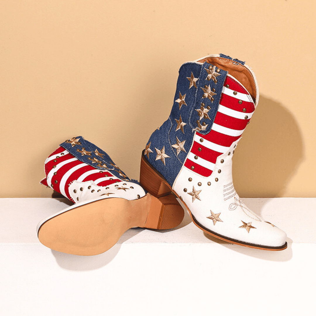 White cowboy boots with red stripes, blue panels and gold star details