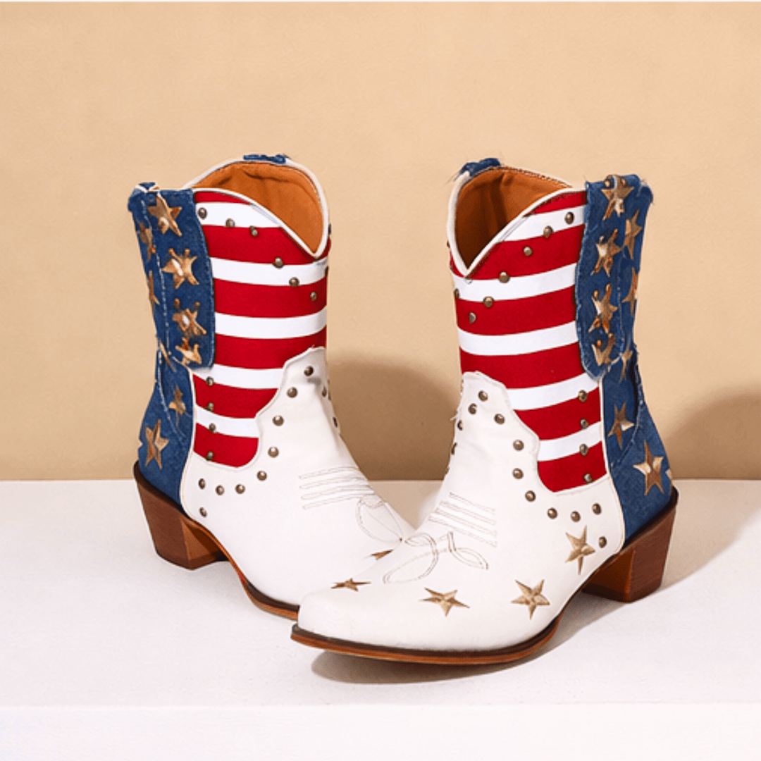 White cowboy boots with red stripes, blue panels and gold star details