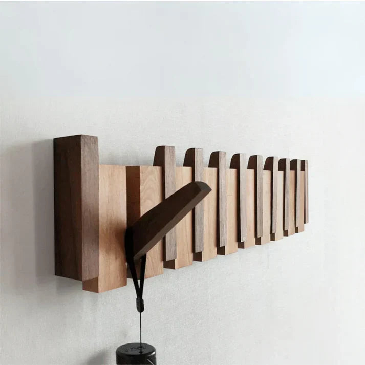 Wooden piano-style wall coat rack with fold-down hooks
