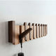 Wooden piano-style wall coat rack with fold-down hooks