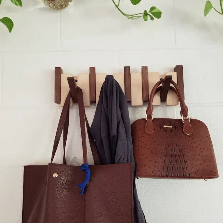 Wooden piano-style wall coat rack with fold-down hooks