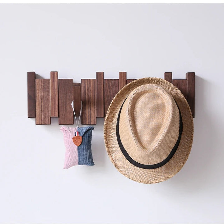 Wooden piano-style wall coat rack with fold-down hooks