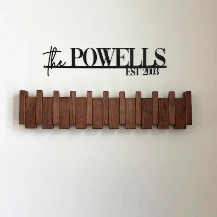 Wooden piano-style wall coat rack with fold-down hooks