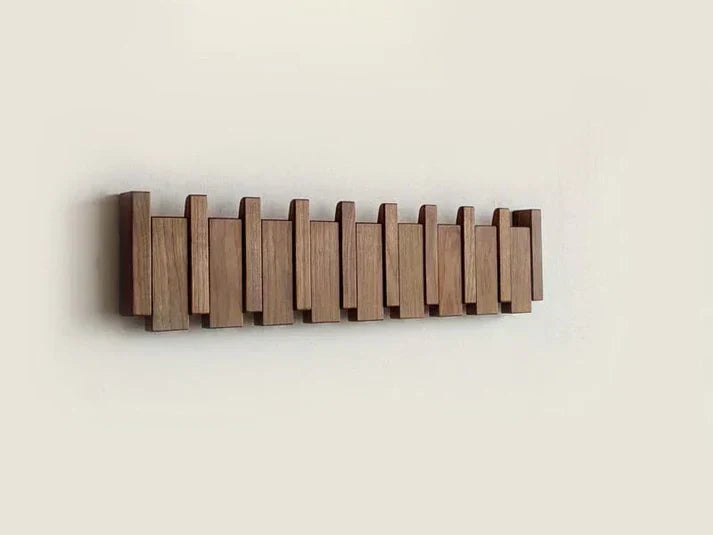 Wooden piano-style wall coat rack with fold-down hooks